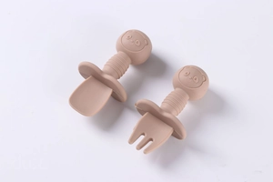 Close-up of baby silicone spoon and fork set with panda handles and anti-choke shields