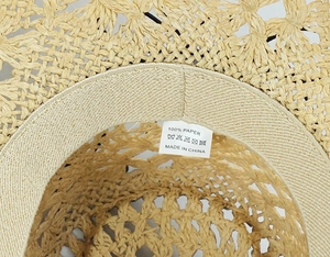 Detail view of 100% paper material label and sweatband on woven straw cowboy hat