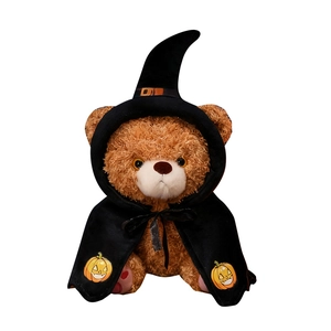 Halloween teddy bear in wizard hat and black pumpkin cloak isolated on white