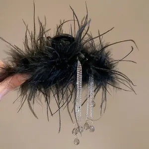 Fairy style hair claw clip featuring black feathers and dangling rhinestone tassels