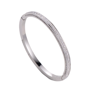 Elegant silver four-row crystal pave bangle bracelet with secure clasp in 18K white gold finish