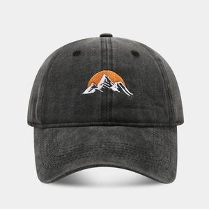 Detail of sunrise and mountain embroidery on washed cotton baseball cap texture