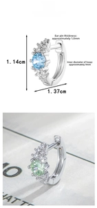Macro detail of S925 silver stud earrings with blue and green zircon stones