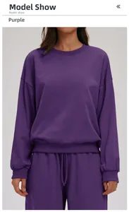 Detail of loose fit dark purple crewneck sweatshirt and joggers set on model