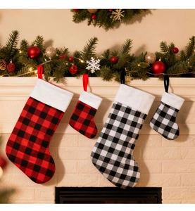 Close-up of four buffalo plaid Christmas stockings hanging on a festive mantelpiece
