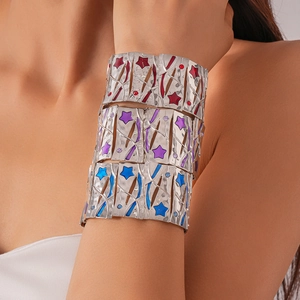 Detail of silver bangles with star-shaped patterns and colorful enamel inlay details