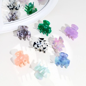 Collection of colorful acetate hair claw clips with marble textures on white background