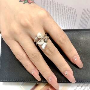 Detail of titanium steel spiral ring with pearl and butterfly on model finger