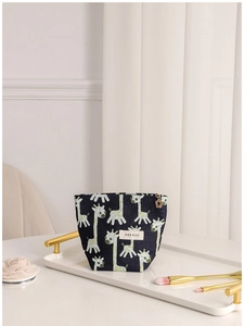 Navy blue giraffe pattern canvas makeup bag with heart zipper pull on white tray