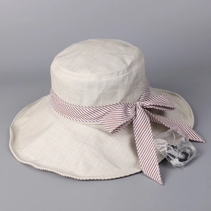 Detail of summer sun hat with striped bow and detachable windproof chin strap