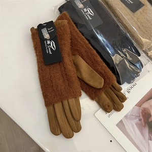 Detail of warm brown suede and knit winter gloves with touchscreen function on index finger