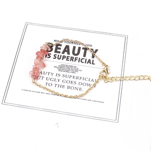 Detail of pink crystal chips on gold chain bracelet with lobster clasp and extension