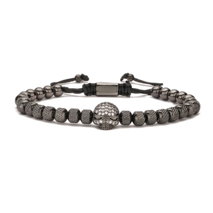 Close-up of black beaded punk bracelet featuring a micro-paved crystal skull and adjustable cord