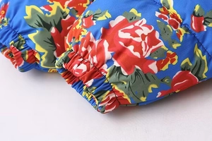 Close-up of windproof jacket sleeve featuring floral print and elastic ribbed cuffs