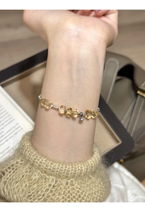 Detailed shot of yellow citrine beaded bracelet with star charm worn on a wrist