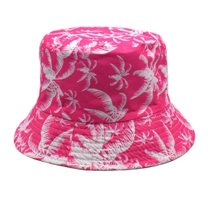 Close-up of tropical white palm tree print on vibrant pink polyester bucket hat