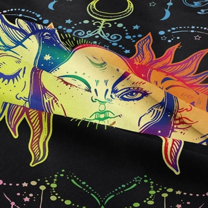 Macro detail of sun and moon pattern on black woven tapestry with rainbow lines