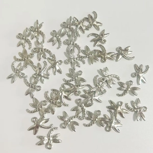 Macro shot of silver plated dragonfly charms for DIY jewelry and beaded phone chains