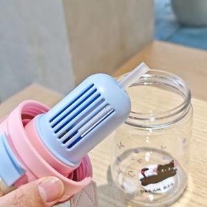 Detail of cute cat plastic water bottle with tea infuser and Dream Big text design