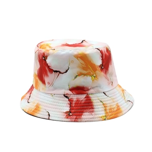 Detailed close-up of warm-toned floral tie-dye pattern on double-sided bucket hat fabric