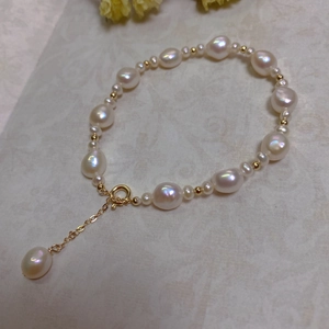 Detailed macro view of baroque pearl bracelet with 14K gold filled beads and lobster clasp