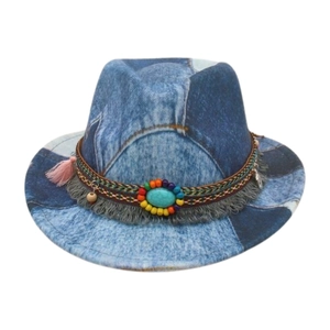 Detail of patchwork denim fedora with turquoise stone and colorful woven band