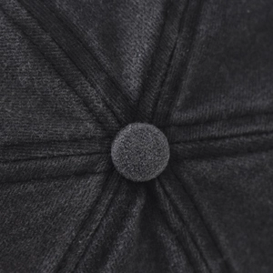Macro shot of dark grey baseball cap top showing stitching and fabric texture