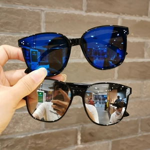 Detail of kids' oversized sunglasses with metal rivets and blue or silver lenses