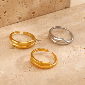 Minimalist double-layer 18K gold plated geometric open rings on beige stone background