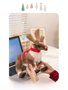 Close-up of a soft reindeer plush with a festive scarf held in hands against a desk