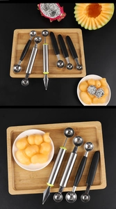 Macro shot of stainless steel fruit scooper and carving knife set on a bamboo tray