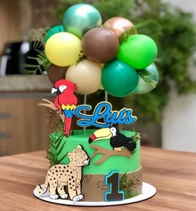 Detail of jungle animal cake toppers with custom name Luis, age 1, and mini balloons