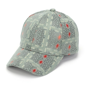 Detail of baseball cap featuring grey cracked texture with red abstract splatter patterns