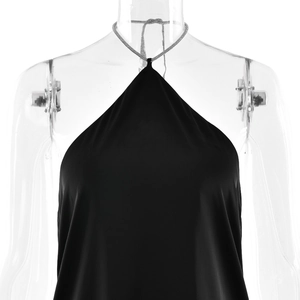 Close-up detail of smooth black satin halter neck dress with backless design on mannequin