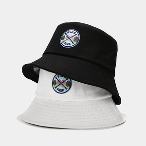 Black and white cotton bucket hats with Wild & Free embroidery patch in casual style