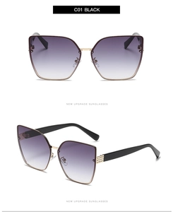 Detailed close-up of cat eye sunglasses with purple gradient lenses and rhinestone accents