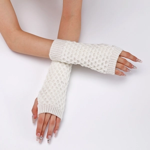 Detail shot of white knitted arm warmers with a delicate diamond hollow pattern for women