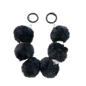 Pair of black plush ball phone charms with pearl beads and silver spring clasps