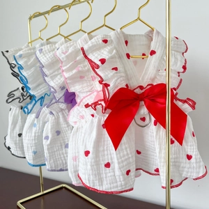 Detail of pet dress showing double-layer gauze fabric, bow, and metal D-ring for leash
