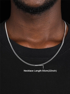 Detailed view of a 55cm silver stainless steel curb chain necklace worn by a male model