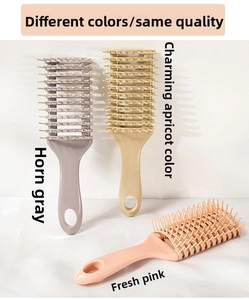 Detail showing three vented hairbrushes in grey, apricot and pink for hair styling