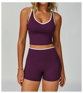 Dettaglio del set sportivo viola con bordi a contrasto bianchi e pantaloncini a vita alta