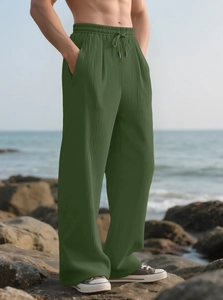 Detail of olive green corduroy wide leg trousers with drawstring elastic waistband