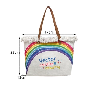 Rainbow pattern woven canvas bag with white fringe details and dimensions 47x35x13cm