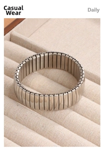 Polished and brushed elastic stainless steel wide bracelet on a jewelry display box