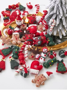 Detail of wool felt Christmas ornaments like gingerbread man and reindeer on a gold tray