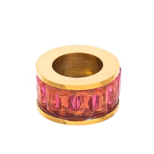 Macro detail of gold ring featuring a row of vibrant pink rectangular-cut zircon stones