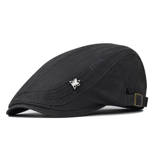 Close-up of black cotton flat cap featuring side wave stitching and adjustable metal buckle