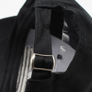 Detail of adjustable cotton baseball cap back strap with silver metal slide buckle