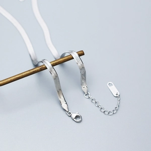 Detail of silver S925 flat herringbone chain bracelet with lobster clasp and extender